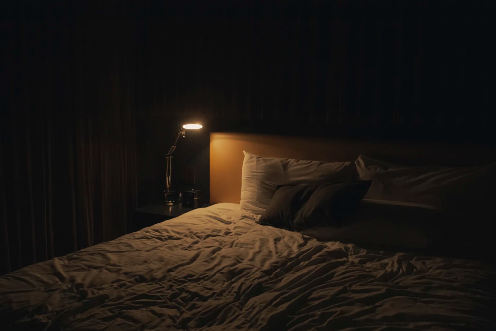 Calm, tidy bedroom with made bed and soft light