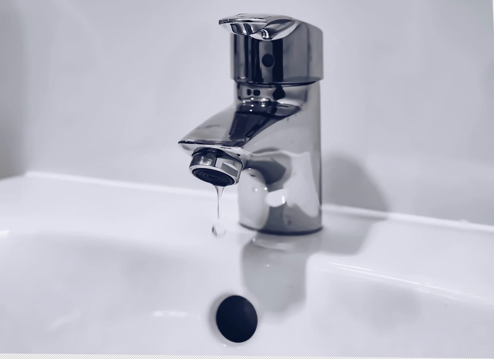 Polished chrome faucet on a clean white bathroom counter