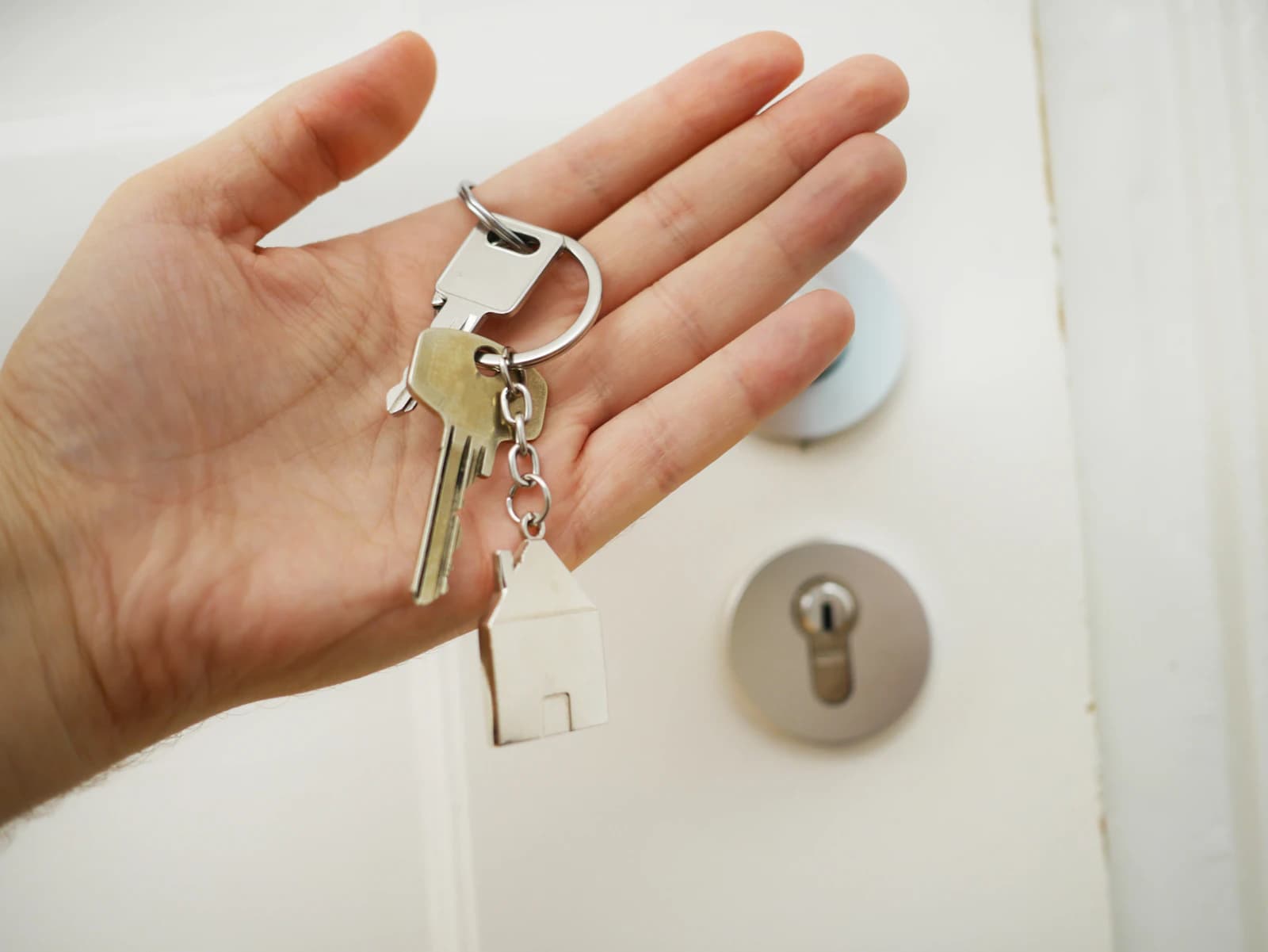 House keys in an open palm at a front door