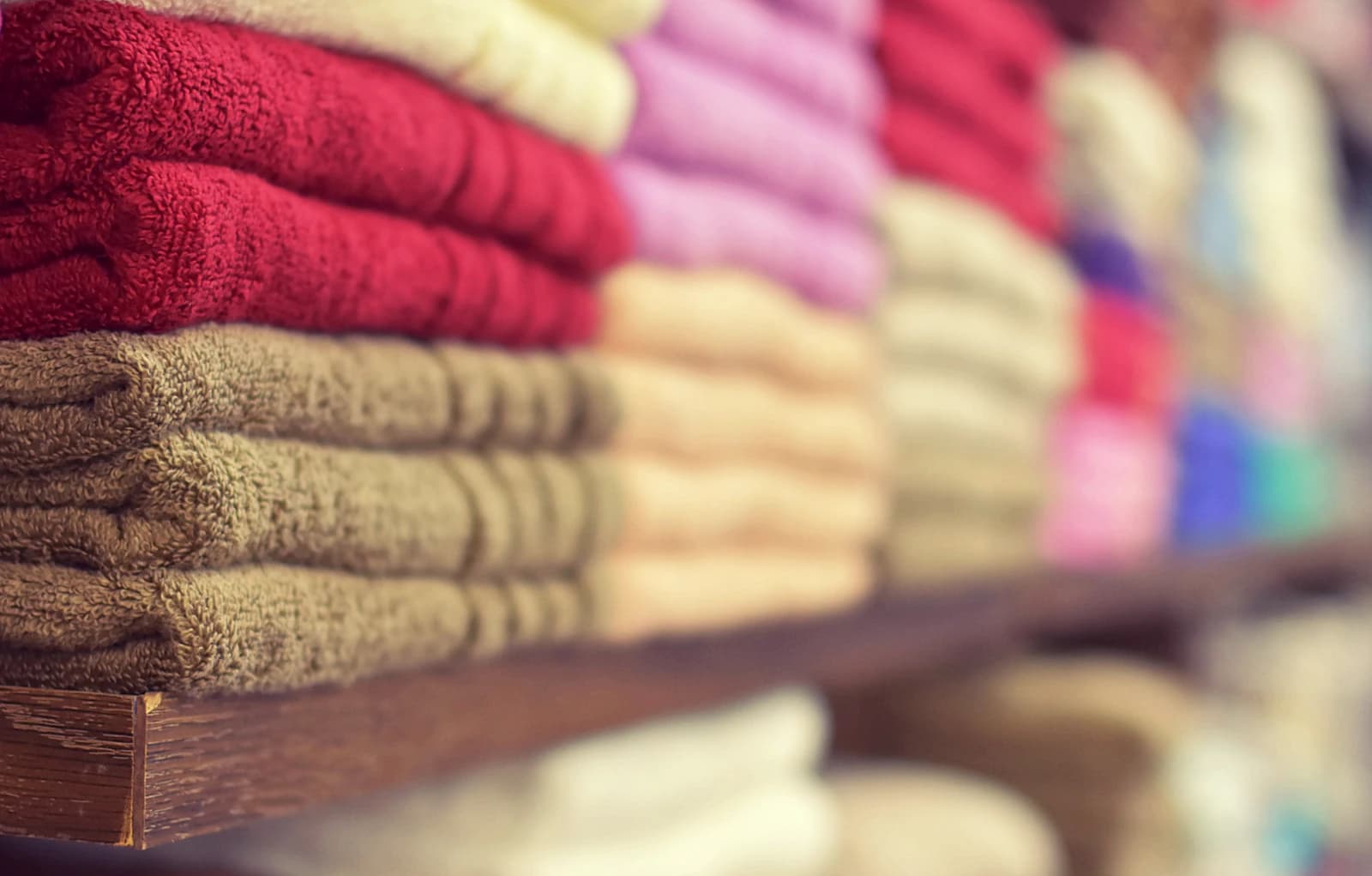 Neatly folded linens stacked on a shelf