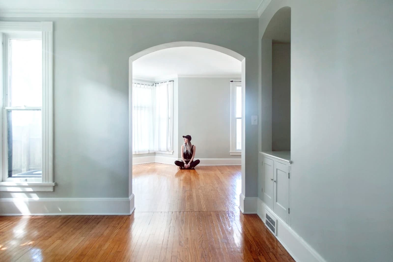 Empty, freshly cleaned room with wood floors and sunlight